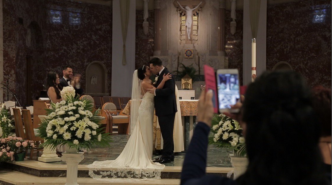 Would have been a really great first kiss photo except the guest obstructed it with her phone - if you look closely, she got mostly floor