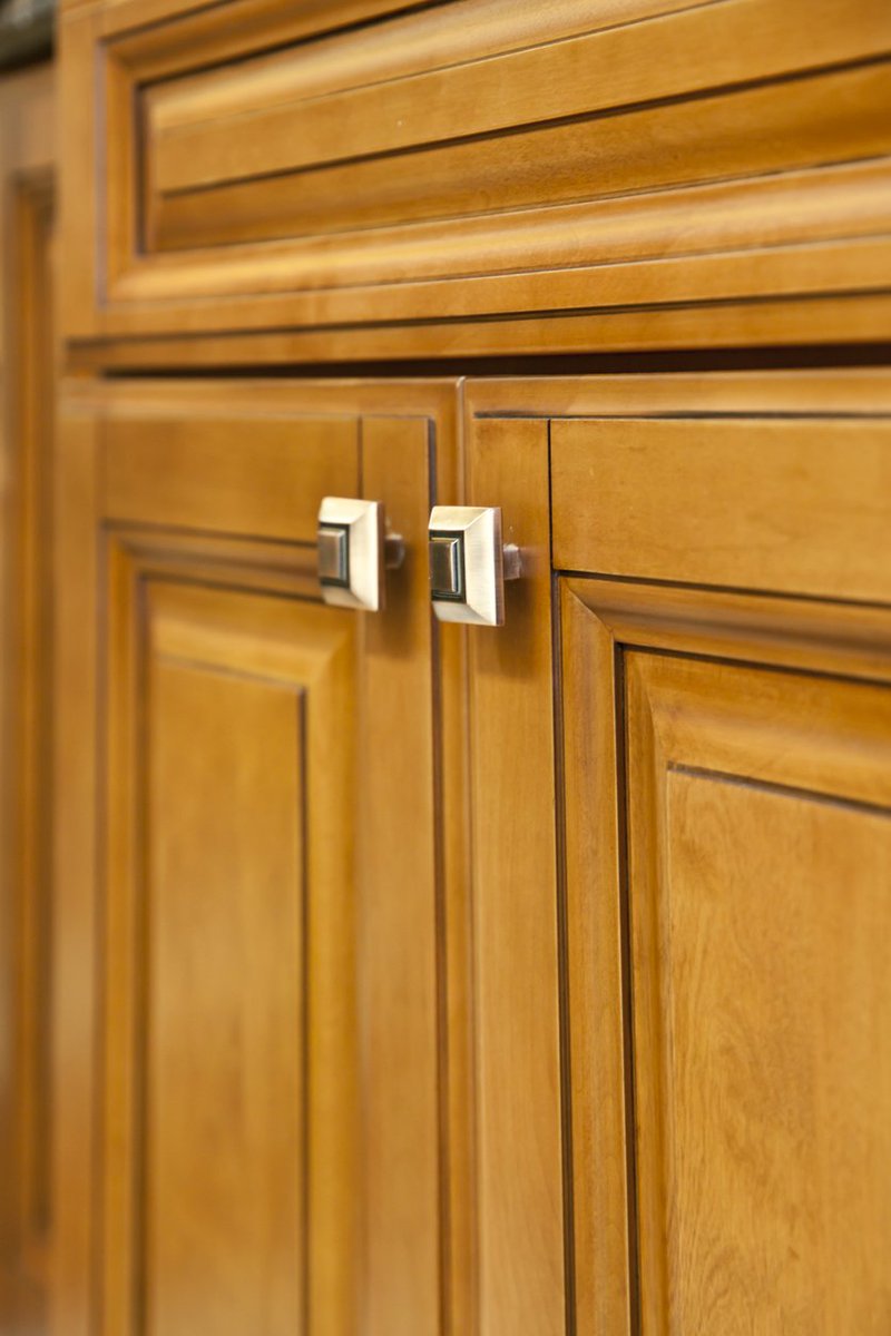 Re-staining wood cabinets and replacing outdated handles is a great way to revamp your kitchen before you put your house on the market.