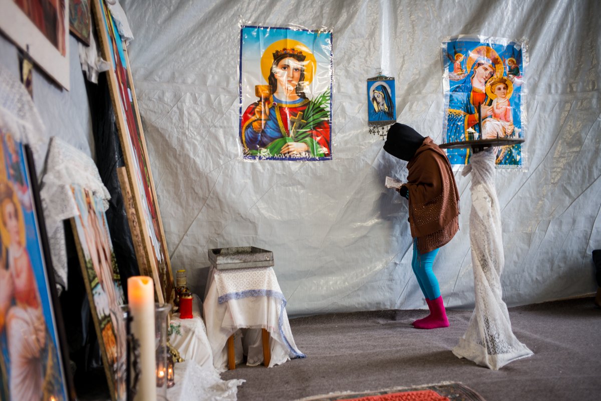 TheOdyssey_Proj's tweet photo. Praying inside the Eritrean church in the South part of the camp – The Jungle, Calais, France, February 2016 #TOP #theodysseyproject #jungle https://t.co/hozBpqAIUj