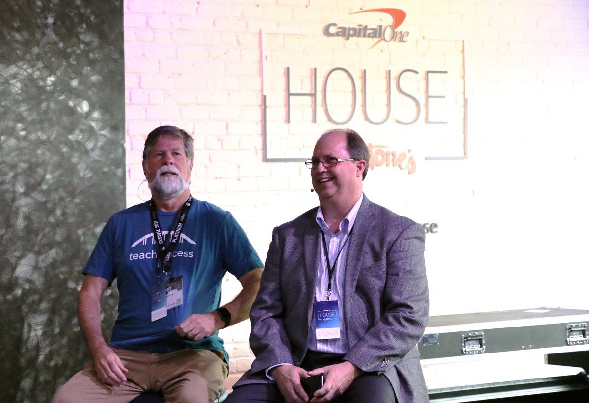 Yahoo Director of Accessible Media and Mike Paciello, CEO of The Paciello Group, share a laugh on stage under a CapitalOne House logo against a white wall.