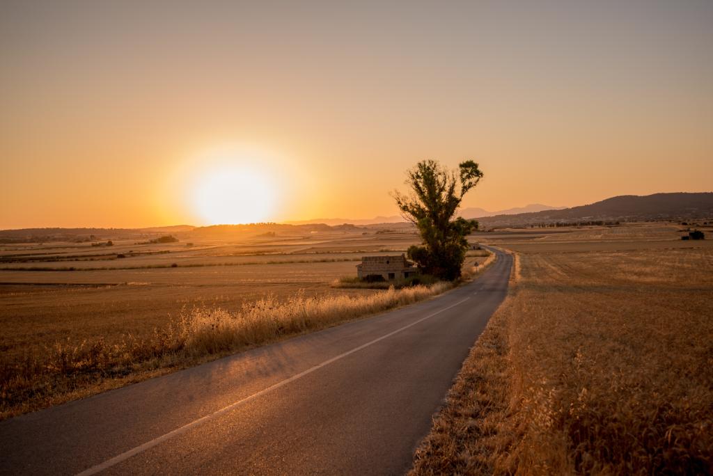 Sunset over an empty country road