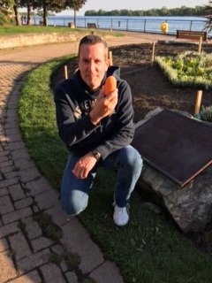 An Orange painted rock found by the beautiful Canada 150th Flower bed in Kings Navy Yard Park. #Aburgrocks