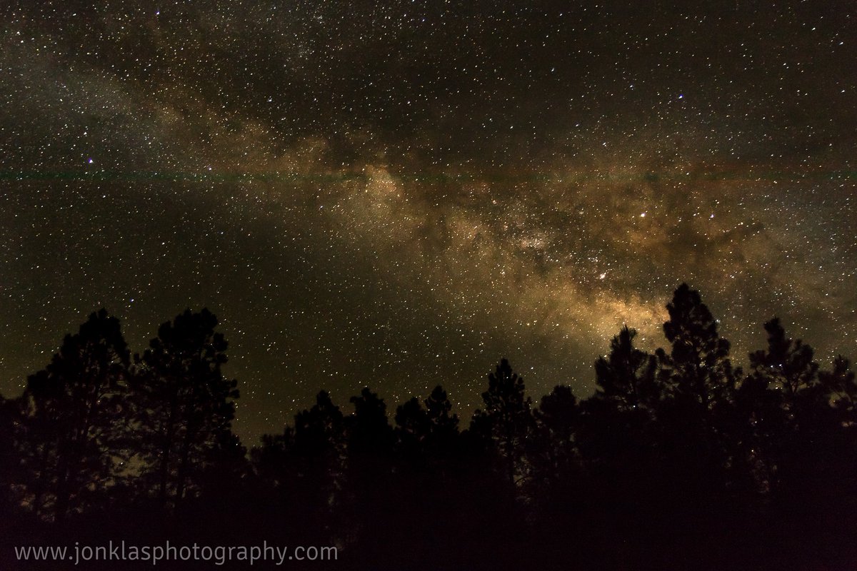JonKlas's tweet photo. Captured this image of the #MilkyWay out in the AZ #wilderness. Majestic Ponderosa Pines providing the #silhouette! #CanonUSA #CanonFavPic https://t.co/Gg58o1a2Qa