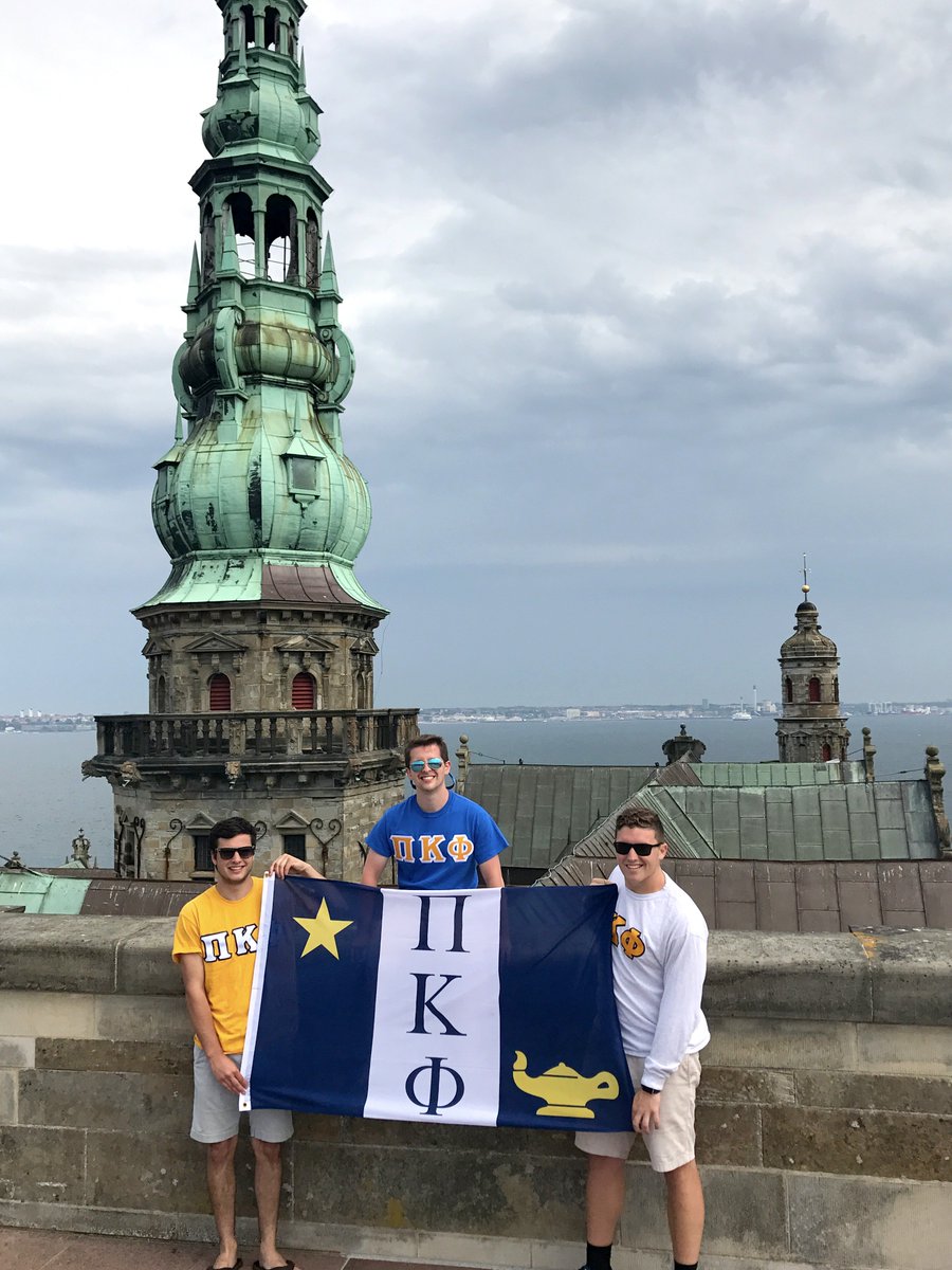 PiKappaPhi's tweet photo. Ryan Mackintosh, Cody Hicks &amp; Logan Deese, @PiKappaPhiEtaMu (Wingate), repping ΠΚΦ on the rooftop of Hamlet's Castle in Denmark. #FlagFriday https://t.co/aSqI41W3Jp