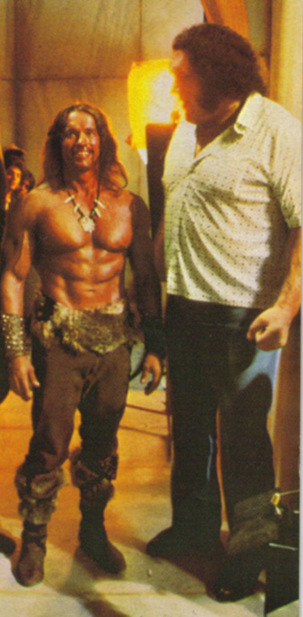 Andre the Giant making Arnold Schwarzenegger, dressed as his character Cona...