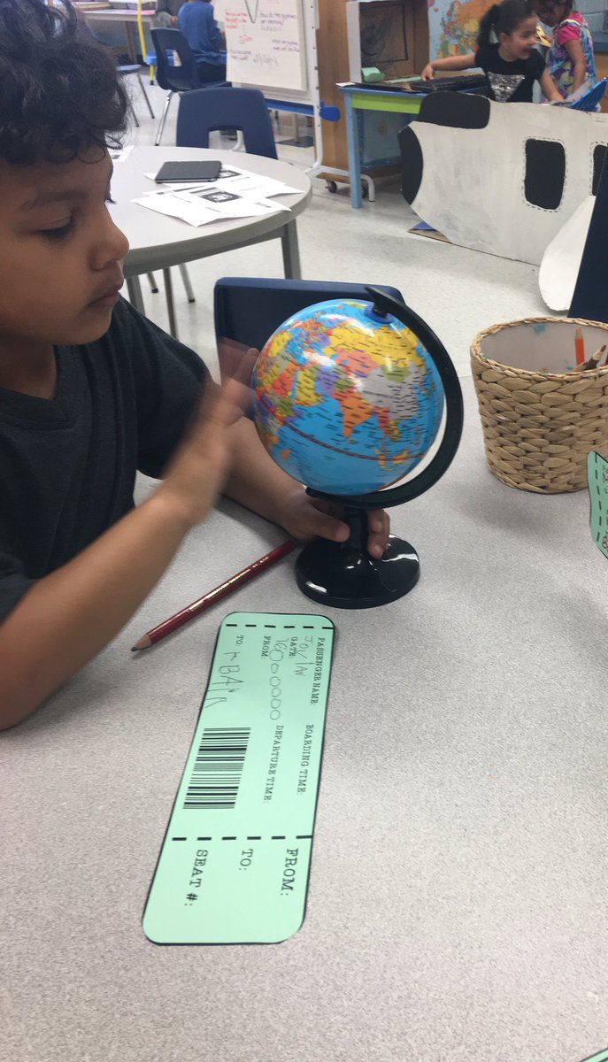 Writing our boarding passes and using our globe and maps to help us decide <a href="/MadocDrive/">Madoc Drive PS</a>