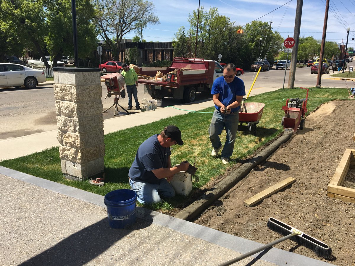 Finishing touches at Dorie's House. LMO Landscaping installed a curb for our shrub-and-flower bed.  Thank you for your generous donation!