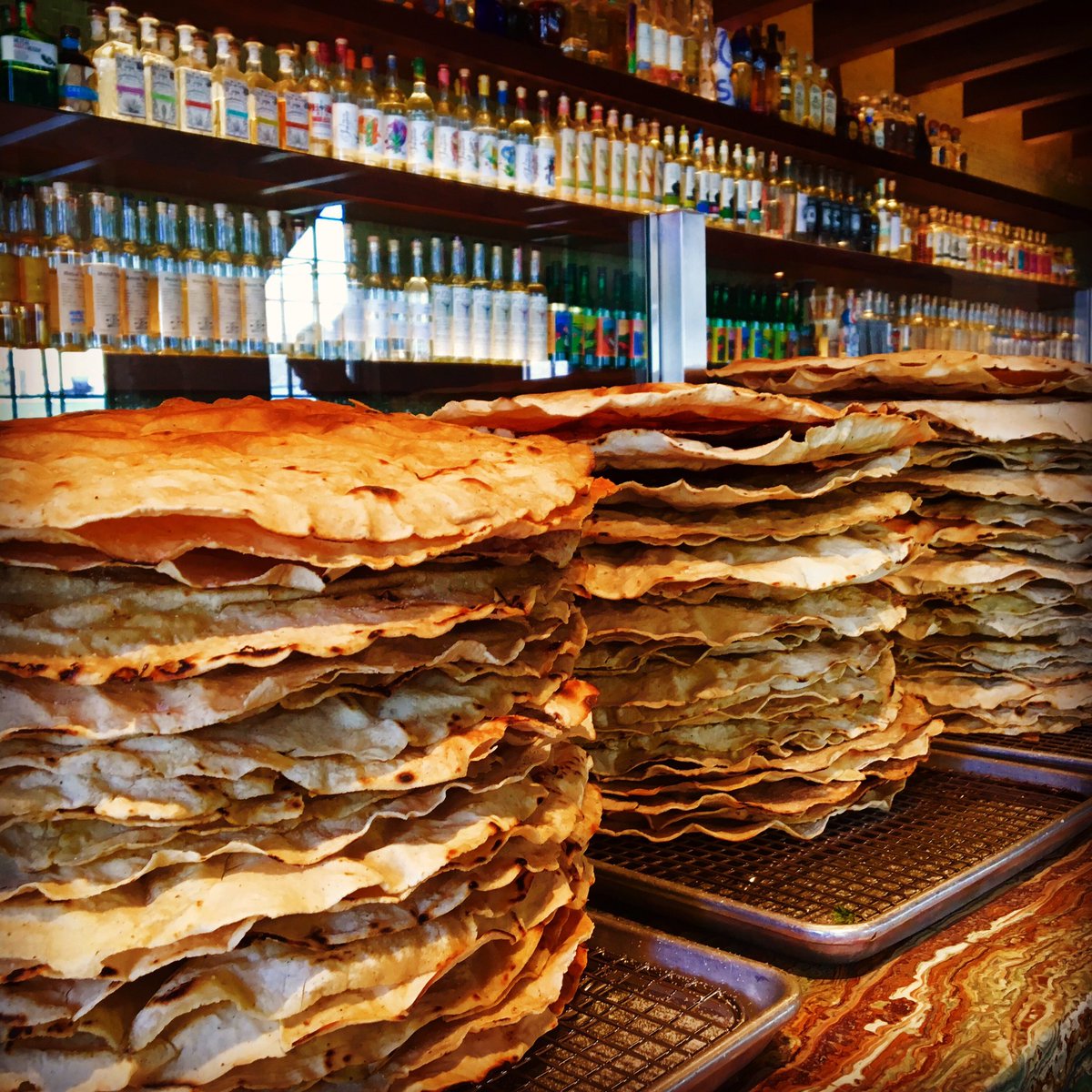 Rick_Bayless's tweet photo. Grill-crisped tlayudas for dinner service @lenabravachicago.  Plus 160 expressions of Mezcal.  Hungry? Thirsty? https://t.co/Fq4FGBpLIY