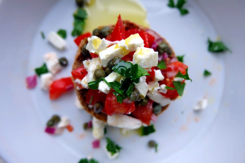 Dakos - Cretan #barley rusks topped with tomato, feta &amp; red onion salad, w/ capers, parsley + red wine vinegar, allspice, olive oil dressing