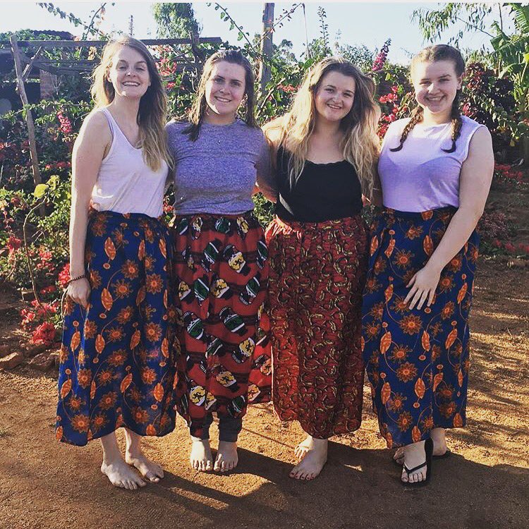 Students4Malawi's tweet photo. Team 1 girls have had some new skirts made - fitting right in to the village #studentsformalawi #summer2017 https://t.co/xPJPmMoIPp