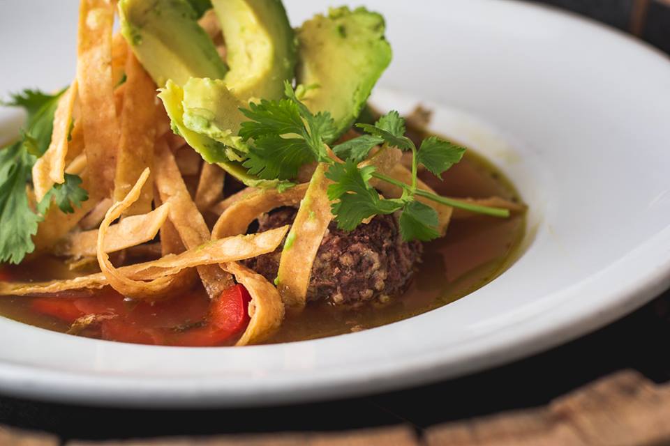 Our Albondigas Soup is served with 3 Mexican meatballs stuffed w/ fresh herbs &amp; rice, stewed tomatoes, avocado, &amp; corn tortilla strips.
