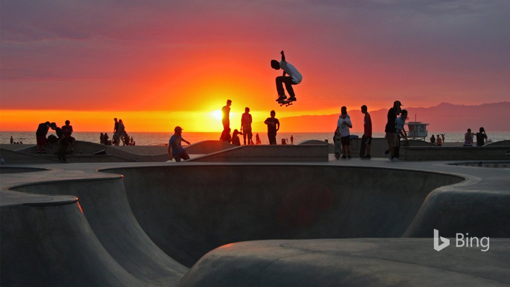 Skateboarders catch air at sunset at Venice Beach, California. Bing.com