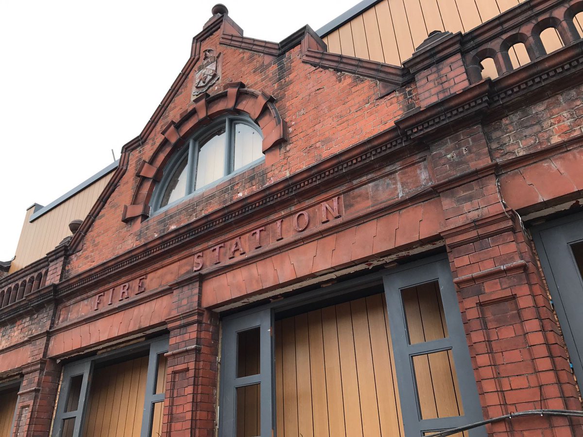 The scaffold has been stripped to unveil the new facade.  We've dropped a huge box in the fire station!