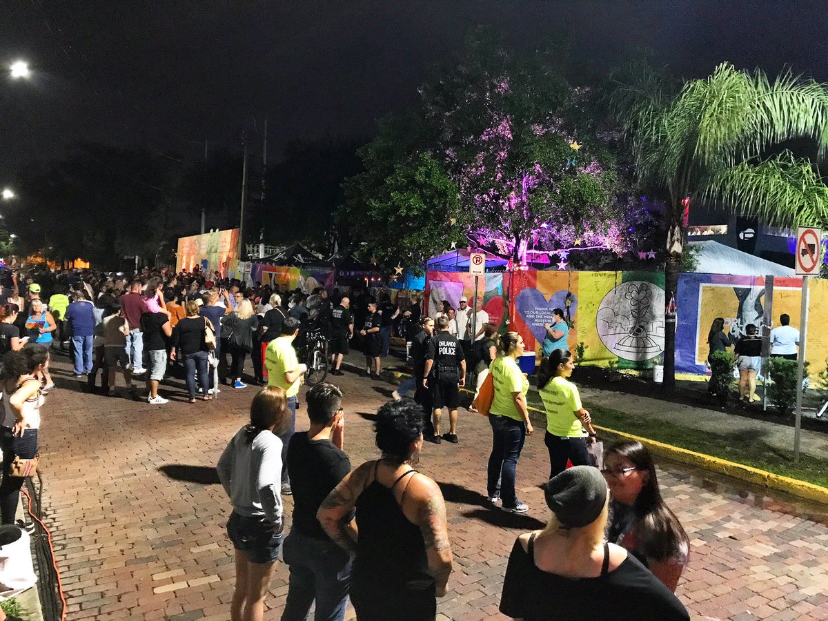 JustinWarmoth's tweet photo. Hundreds have gathered outside Pulse nightclub as we approach the exact moment 49 lives were taken one year ago. https://t.co/IFYZlkaGql
