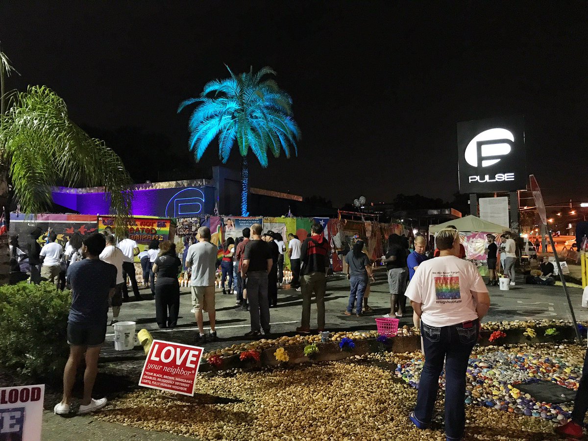 JustinWarmoth's tweet photo. Hundreds have gathered outside Pulse nightclub as we approach the exact moment 49 lives were taken one year ago. https://t.co/IFYZlkaGql