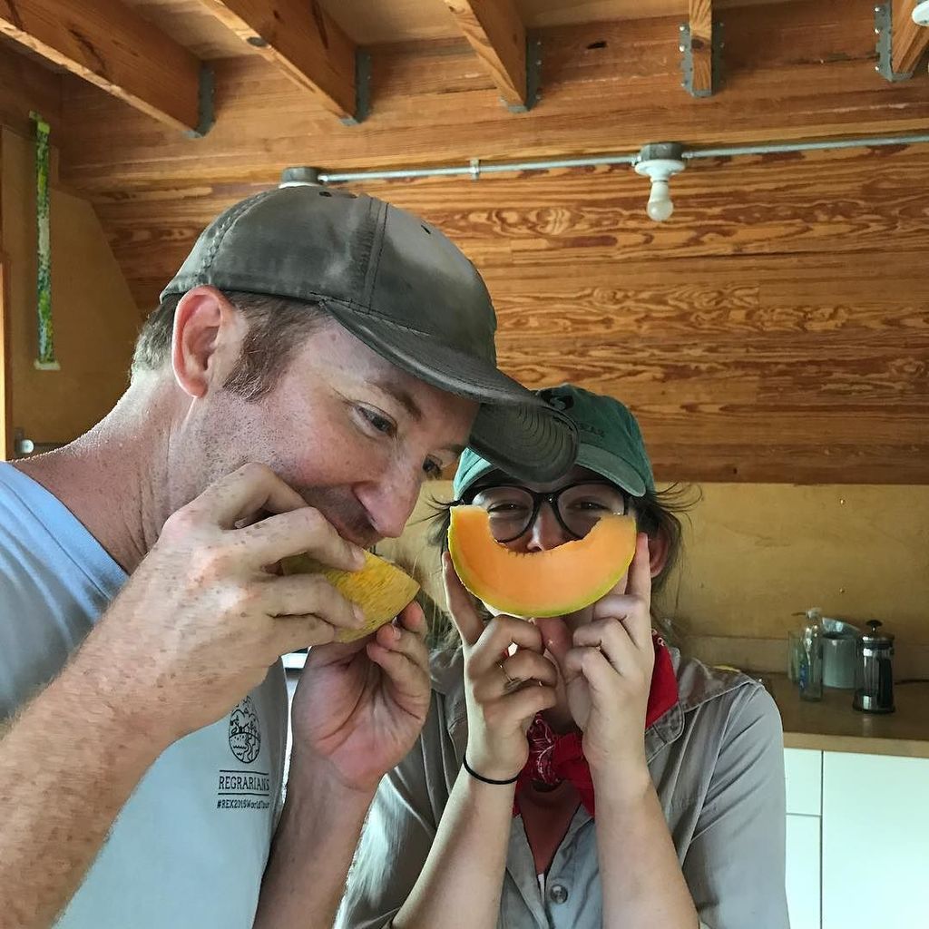 Taste testing the first melon of the season! Juicy and sweet, according to Jillian's cantaloupe smile! #summer #melon #organic #local #farm…