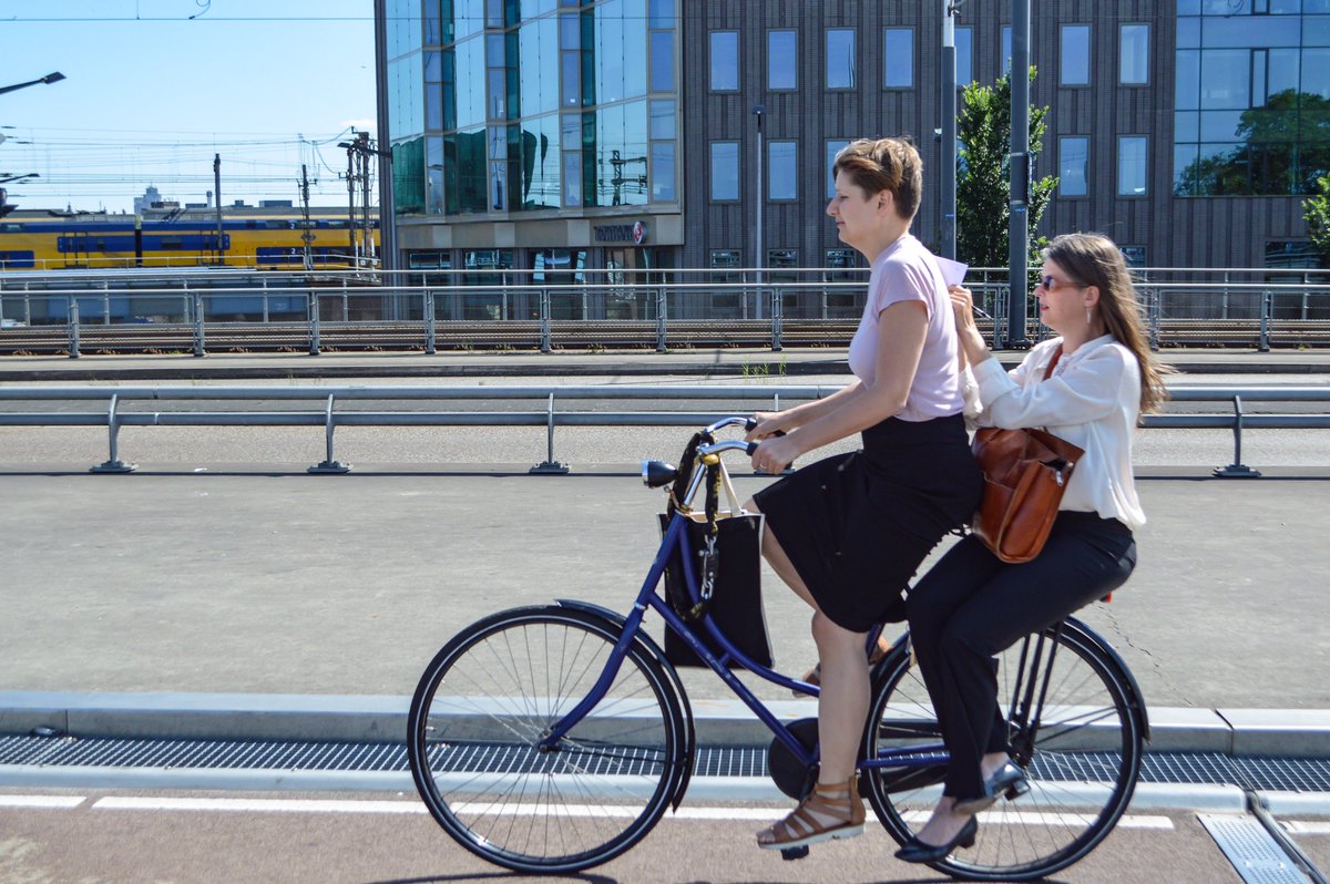 Every day in the Netherlands we manage to spot a new activity on a bike. Today it was a woman marking an academic paper from the back rack!