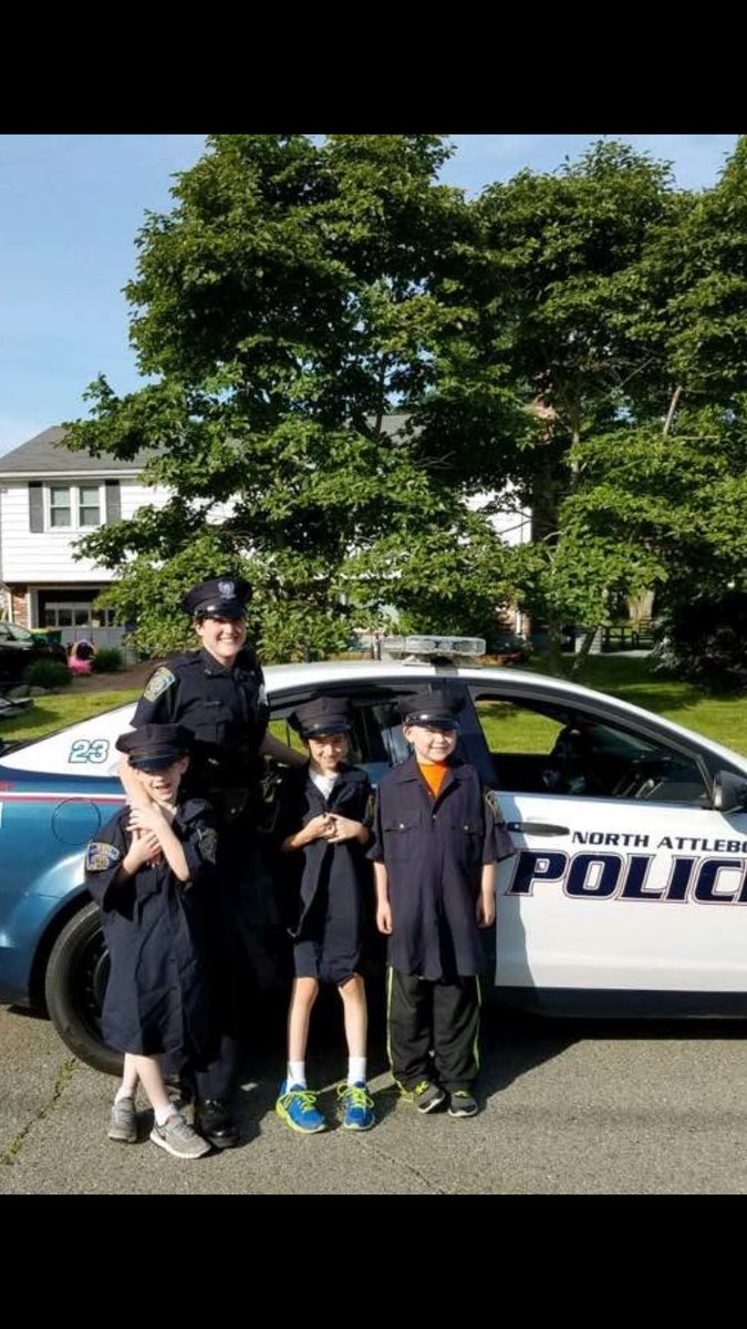 Annual "Roosevelt Ride to School with a Police Officer" winner (and his two friends) posing with Officer Crosman.