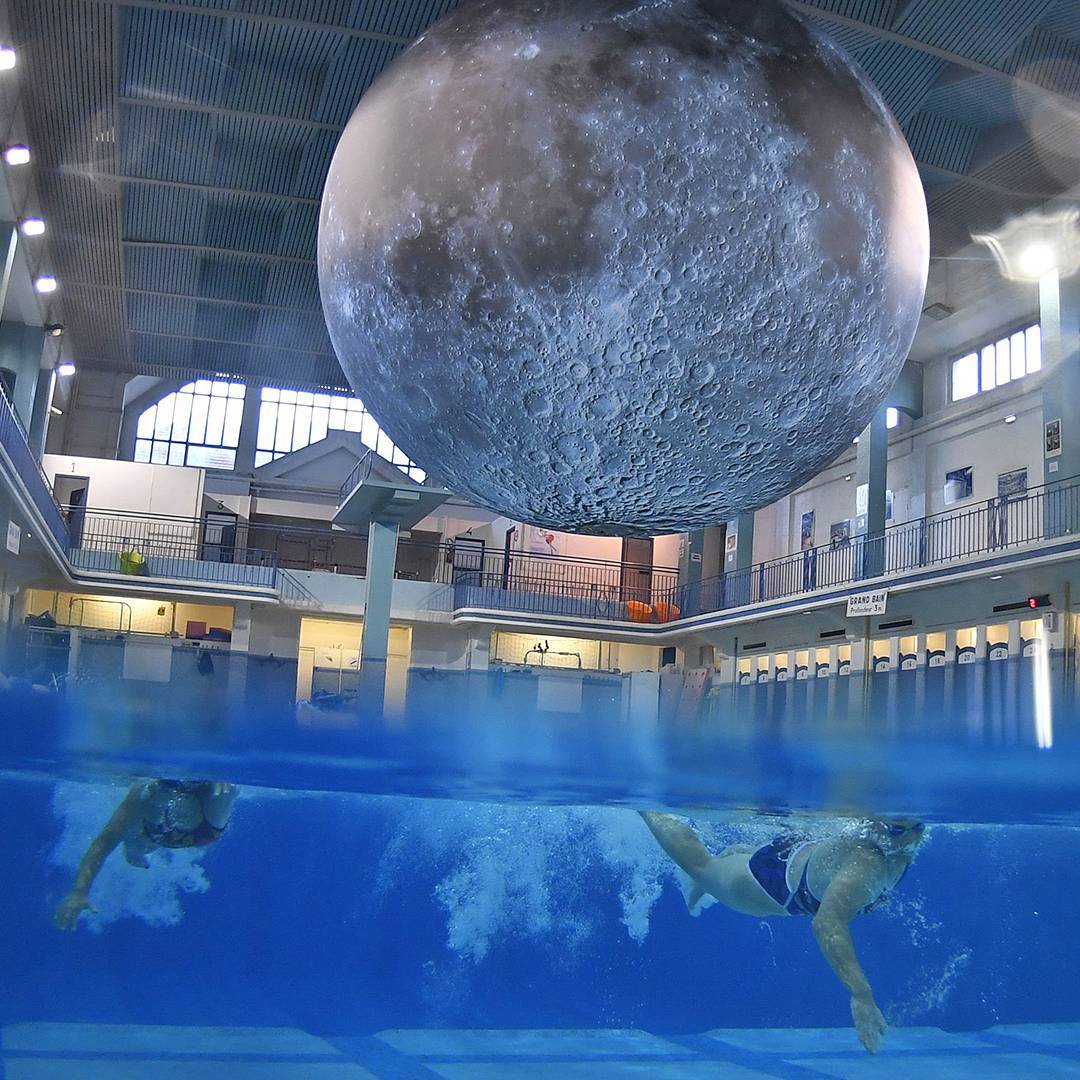 TheEconomist's tweet photo. "Museum of the Moon", a touring art piece by British artist Luke Jerram, is currently installed at a swimming pool in Rennes, France (AFP) https://t.co/N1nQ8sqpvX