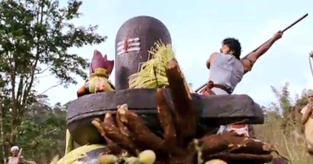 Amarendra & Mahendra carrying gods to safeguard their mother. Father(Amarendra) carrying son(Ganesha) & son(Mahendra) carrying father(Shiva)