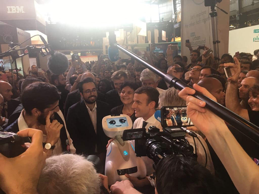 adoptbuddy's tweet photo. Buddy, the companion #robot imagined by @Hasselvander_R, CEO of Blue Frog, in the arms of the French president @EmmanuelMacron #VivaTech https://t.co/upNp3ZLJlh