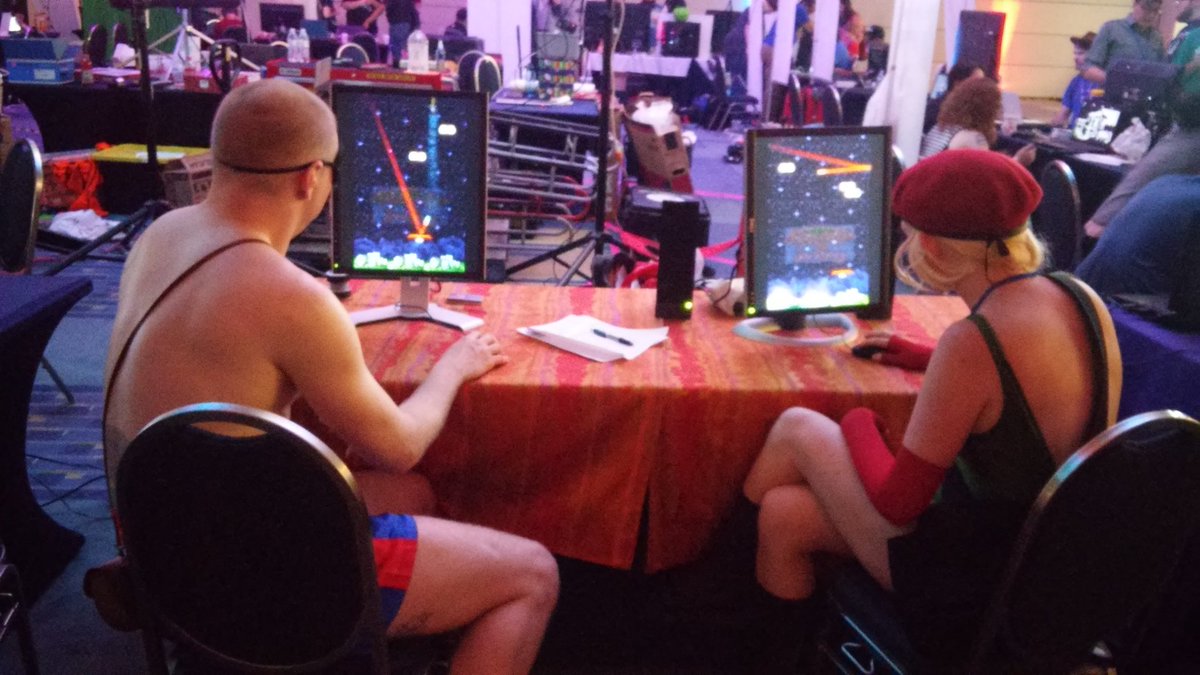 weirdGameDev's tweet image. Cammy and Sagat playing #interstellarInvader at #awesomeCon!!