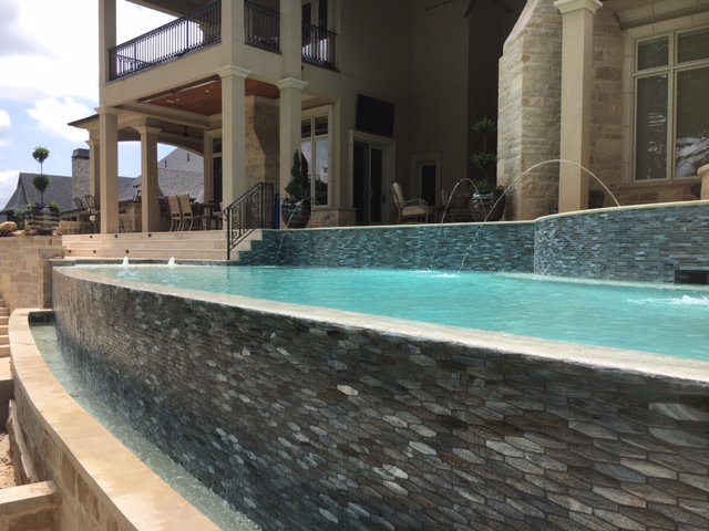 OKSignaturePool's tweet photo. Negative edge pool with glass tile and bubblers #luxurypoolsmag #pooldesign #architecture #swimmingpools #outdoorliving #tulsapeople https://t.co/a1UB7E6cFJ