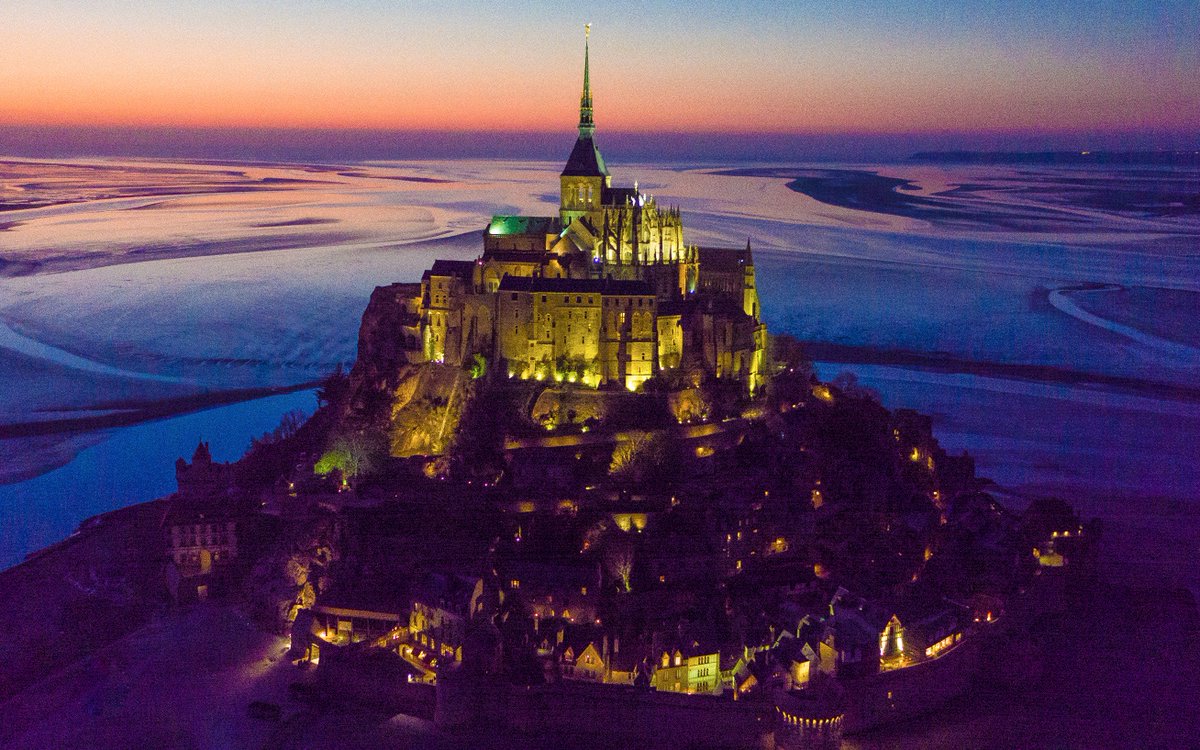 A monastery crowns the top of an island fortification, a remnant of French feudalism made inaccessible at high tide. #drone #France