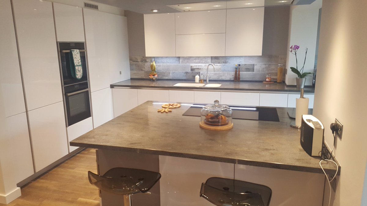 kitchensinbath's tweet photo. Schmidt handleless Gloss units w/ Corian worktops, strip LED downlights built-in to the wall units &amp; lovely tiles for the splashback https://t.co/wqWIjgK5uL