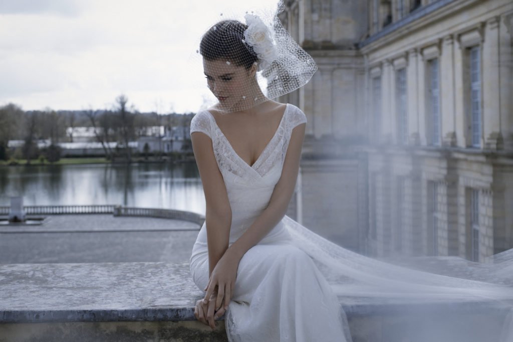 The lovely 'Baleares' dress by <a href="/CymbelineParis/">Cymbeline</a> , is an empire #bridaldress in Calais #lace, ending generously in the back by two shirttails.