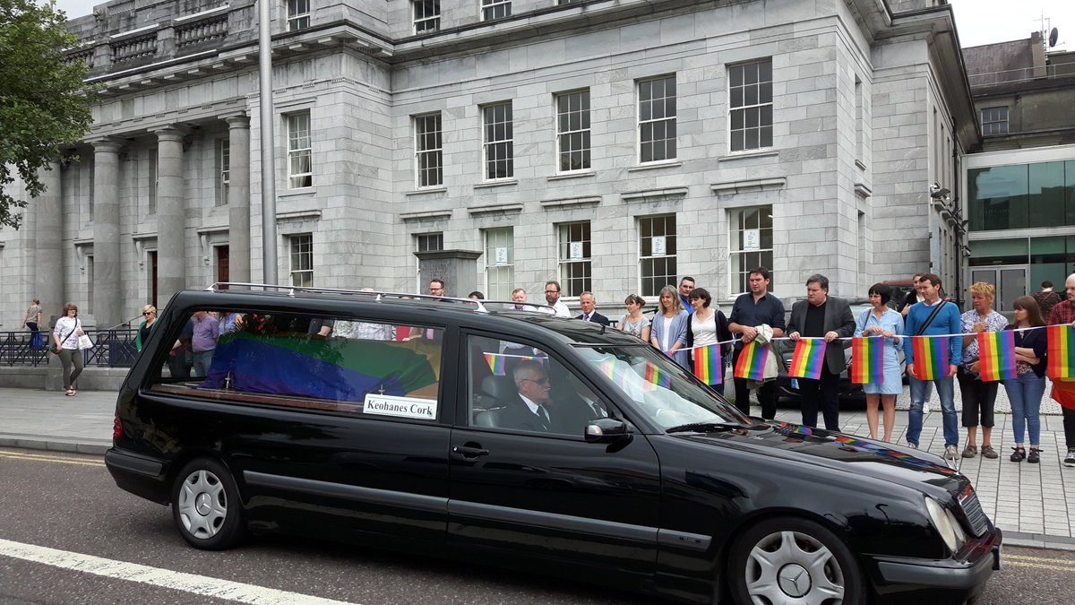 corkcitycouncil's tweet photo. Huge crowd gathered as the funeral cortege for the late Dave Roche passes by City Hall #cork #lgbtcork https://t.co/AsuNSkagOt