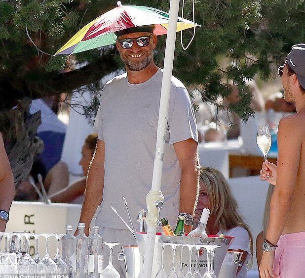 charlesthetooth's tweet photo. People argue about which team has the best manager, but in the end ours wears an umbrella hat. #NoFurtherDiscussion https://t.co/mWgsu9LEZN