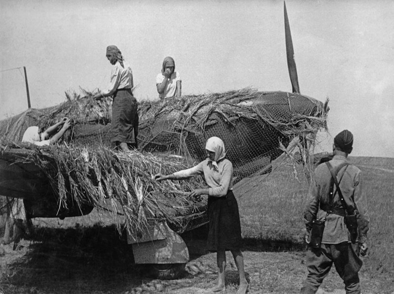 Local women camouflage a Soviet Yak-1. 1941