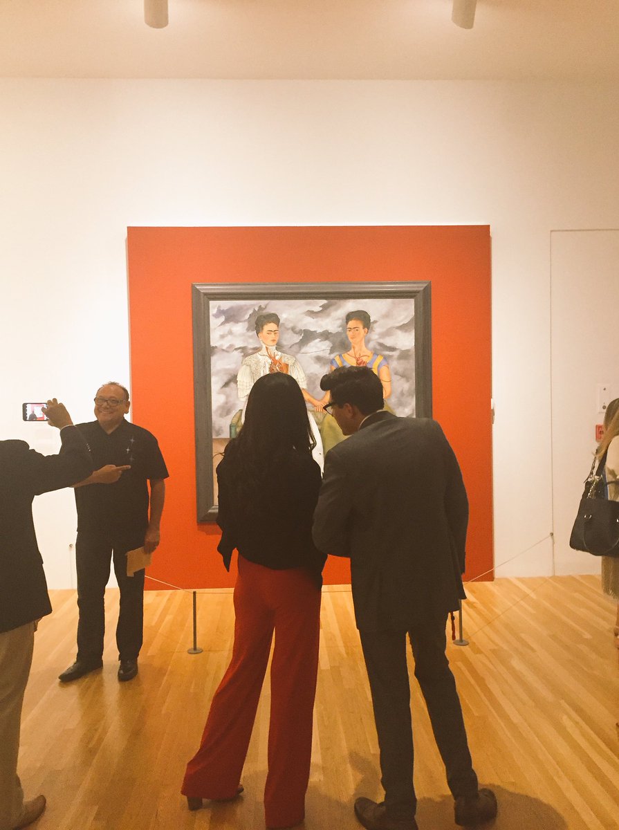 latinocld's tweet photo. "I can't believe it's here. This is gonna be my wallpaper" mentions an exhibition goer as she makes her way to Las Dos Fridas @NALEO https://t.co/rm6RjEXJL0