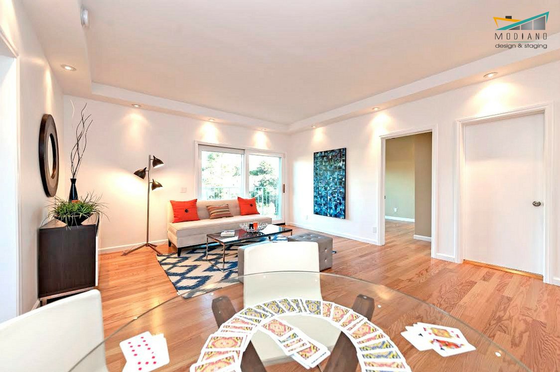 ModianoDesign's tweet photo. Fun Friday with the fam! The stylish glass table doubles as a game table. Play cards, board games, and more! #StagedByModiano #HomeStaging https://t.co/wgCyb6UA5f