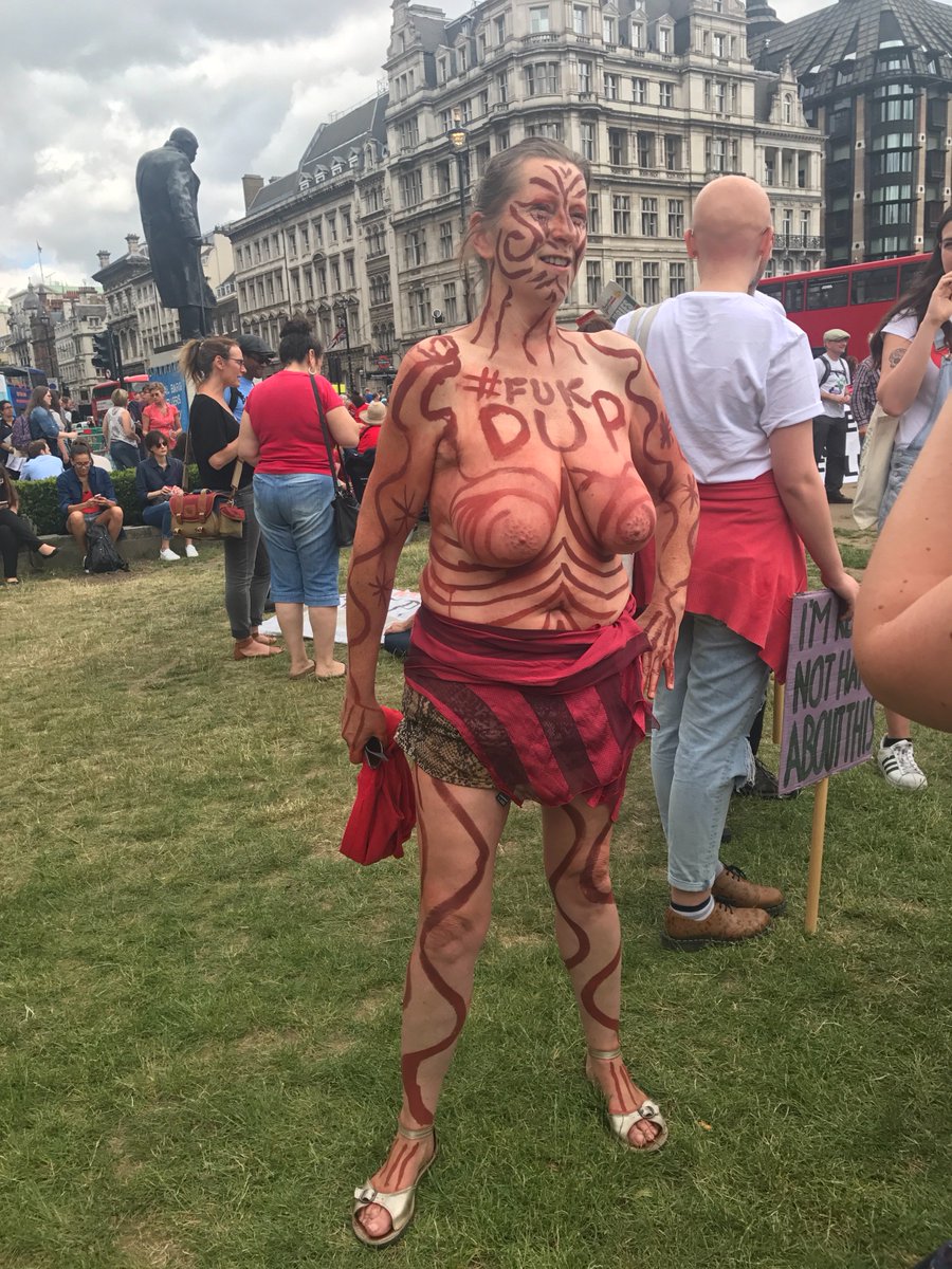 MarchAgainstDUP's tweet photo. Police were insisting she cover her chest at #womensmarch against Tory-DUP - until 2male allies removed their tops in support. #heforshe https://t.co/SUUhj9GFdd
