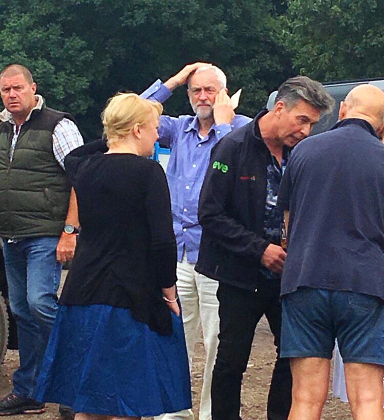Theresa May at Armed Forces Day and Jeremy Corbyn looking confused in a field.