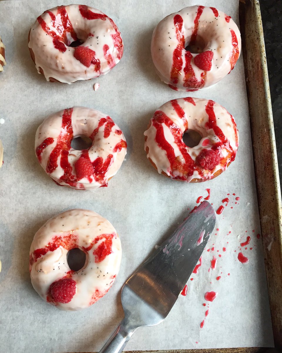 VeggieGalaxy's tweet photo. Lemon Raspberry doughnuts on the tray. A few poppyseeds for the #crunchfactor. Available #vegan or #gf/vegan. 😋 https://t.co/lcxiFCWlm8