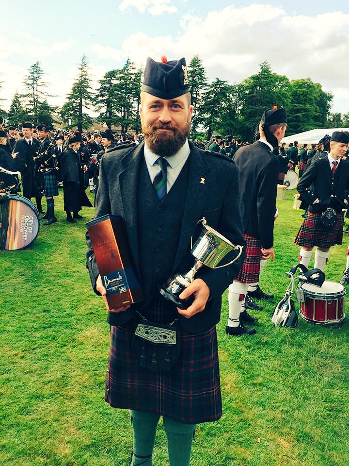 Pipe Major Simpson with his spoils. 🏆🍾- Our very own Pipes&amp;Drums have just been crowned European Champions #Grade3b