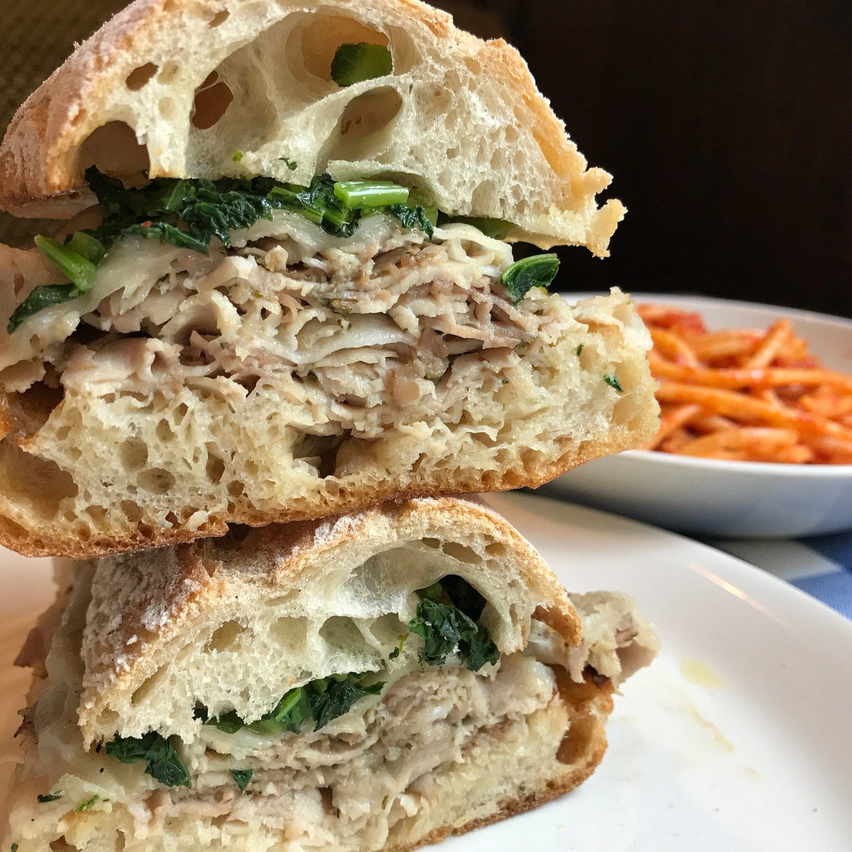 maialino_nyc's tweet photo. A very balanced lunch at your Rome away from home. Porchetta sandwich with some bucatini all’amatriciana peeking out from behind. https://t.co/mPWhHObNvd