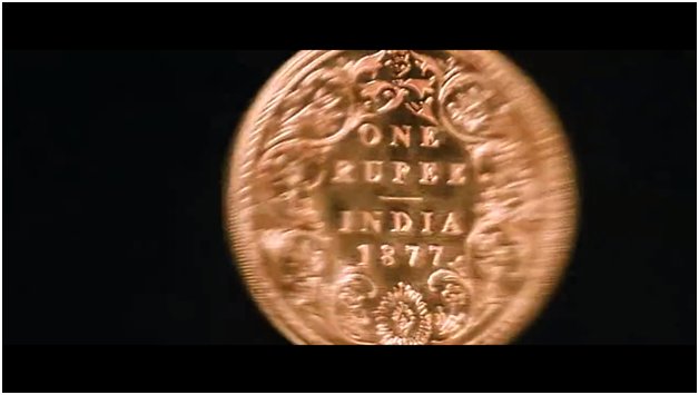 It starts with a 1 rupee coin from 1877, so guess that's when it's supposed to b. Same year as the 1st test. Well played to whoever did that