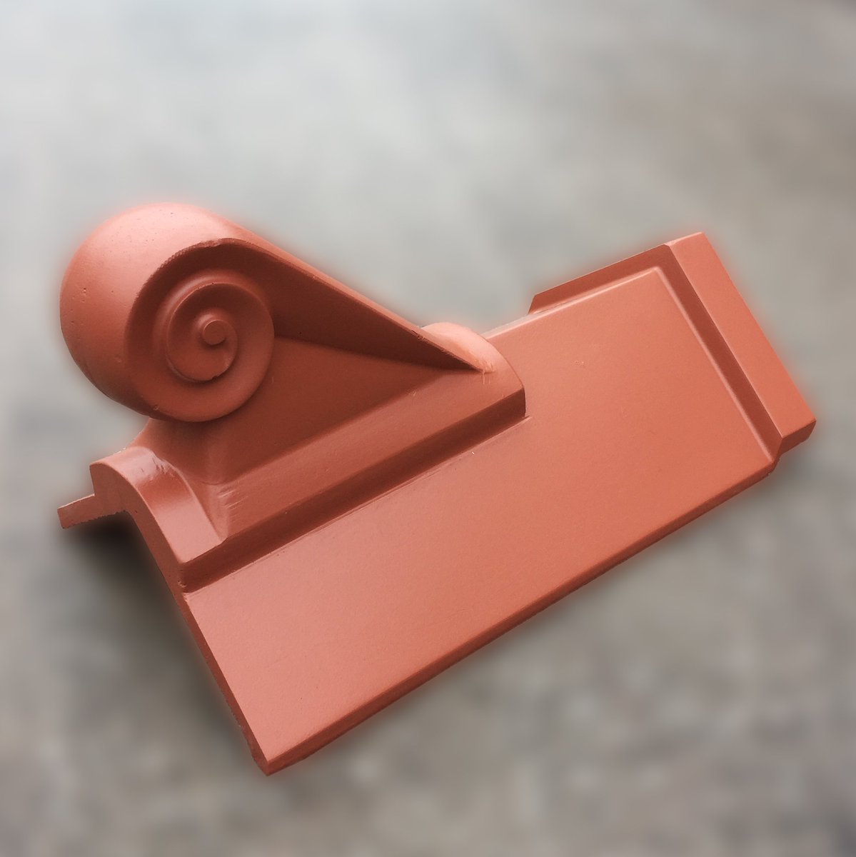 Here at RRS we manufacture Scroll Finials. These can be bespoke fitted to any ridge tile! Shown is a 105 angle capped terracotta red ridge.