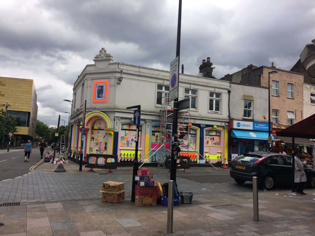 Toothpunk's tweet photo. New paint job and artful layering on #Deptford High Street. Beautiful fluro on alabaster bank corpse. #paintoverthedirt https://t.co/o8eJtShUAx