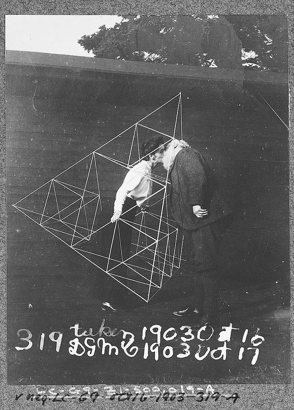 PublicDomainRev's tweet photo. Alexander Graham Bell smooches his wife as she stands inside one of his tetrahedral kite structures. More here: https://t.co/WPmmfvcLHs https://t.co/d7ne8Myajq