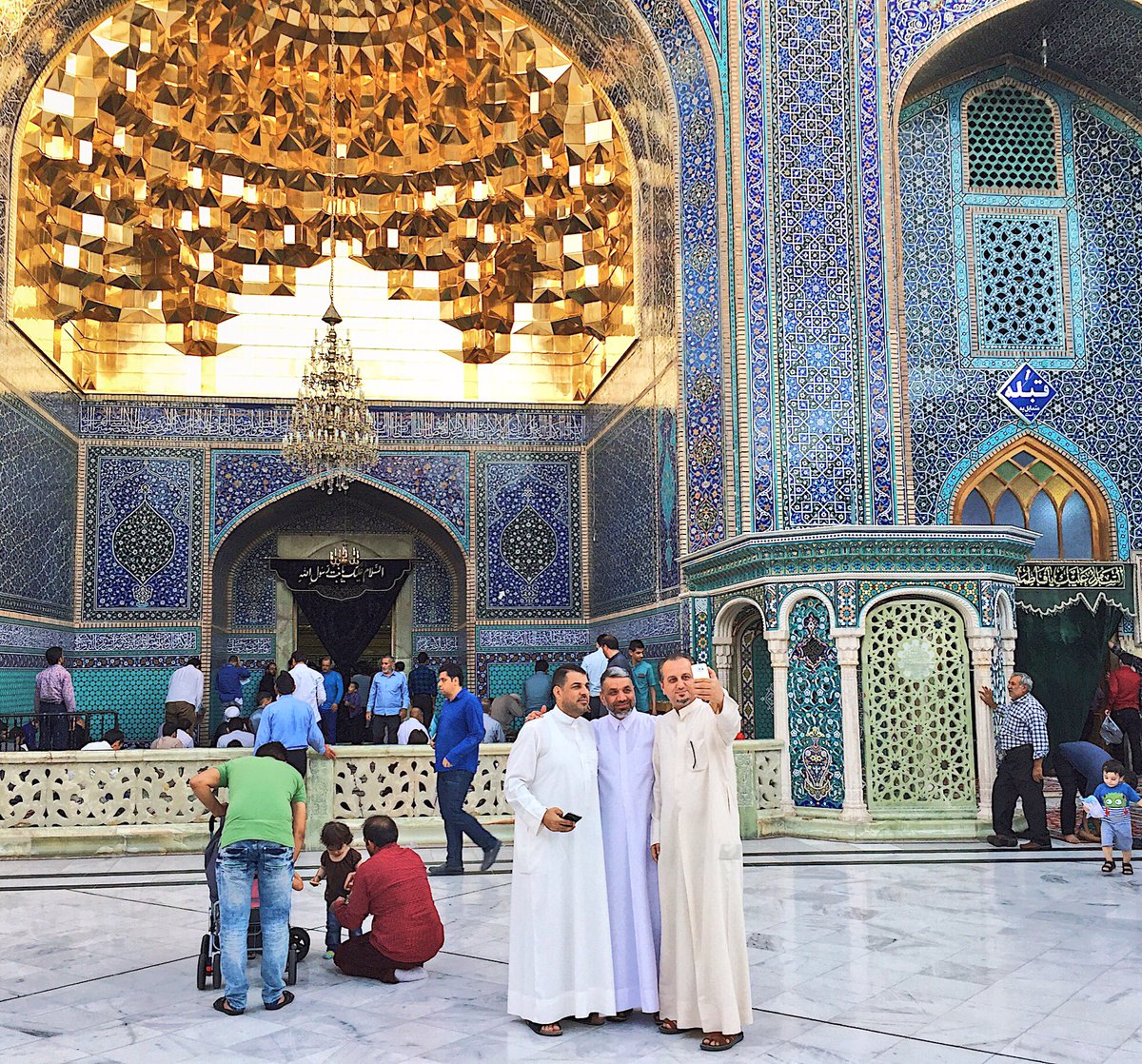 Tourists from  #Iraq take selfies outside the shrine in  #Qom