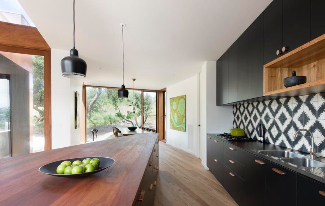 ICMGeelong's tweet photo. Kitchen of the week. Stunning island bench is spotted gum offset with black laminate cabinetry, tiles and brass handles. Windsor Kitchens. https://t.co/jnT9KRoMbP