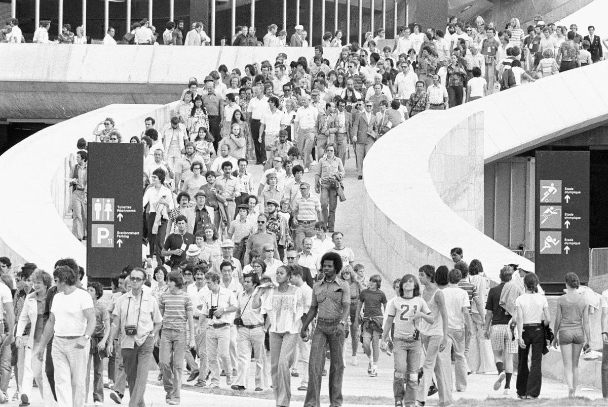 Black and white photo of crowds walking down stadium ramp at the 1976 Olympics in Montreal.