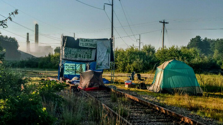 MarlaMarcum's tweet photo. Morning: @QuakerClimate #RootedInReverence encampment on the tracks with friends, giant coal pile, and power plant. https://t.co/A9vlqeG7T9
