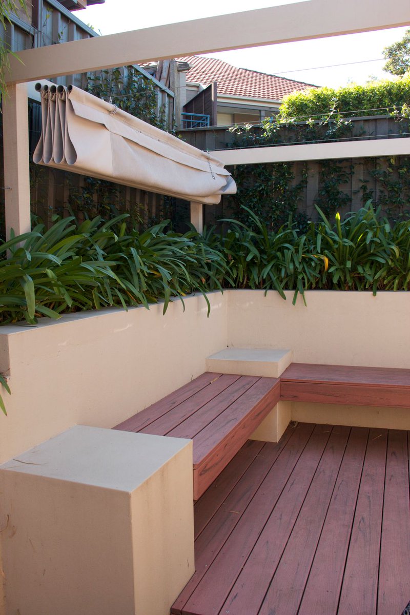 StylishGardens's tweet photo. Benches are space-savers. Our clients have always wanted red timbers. #timberdecking #awning #builtinseating #containergarden https://t.co/TH25VQBQpu