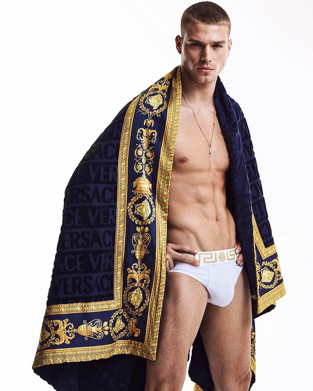 Matthew Noszka in Versace Greek Key briefs and Baroque towel on. 